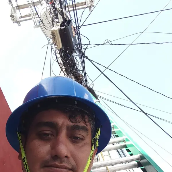 Jorge in hard hat at the base of his ladder